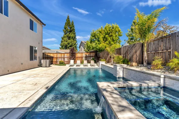a view of a backyard with sitting area