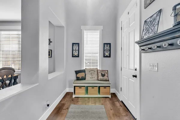 a view of entryway and hall with wooden floor