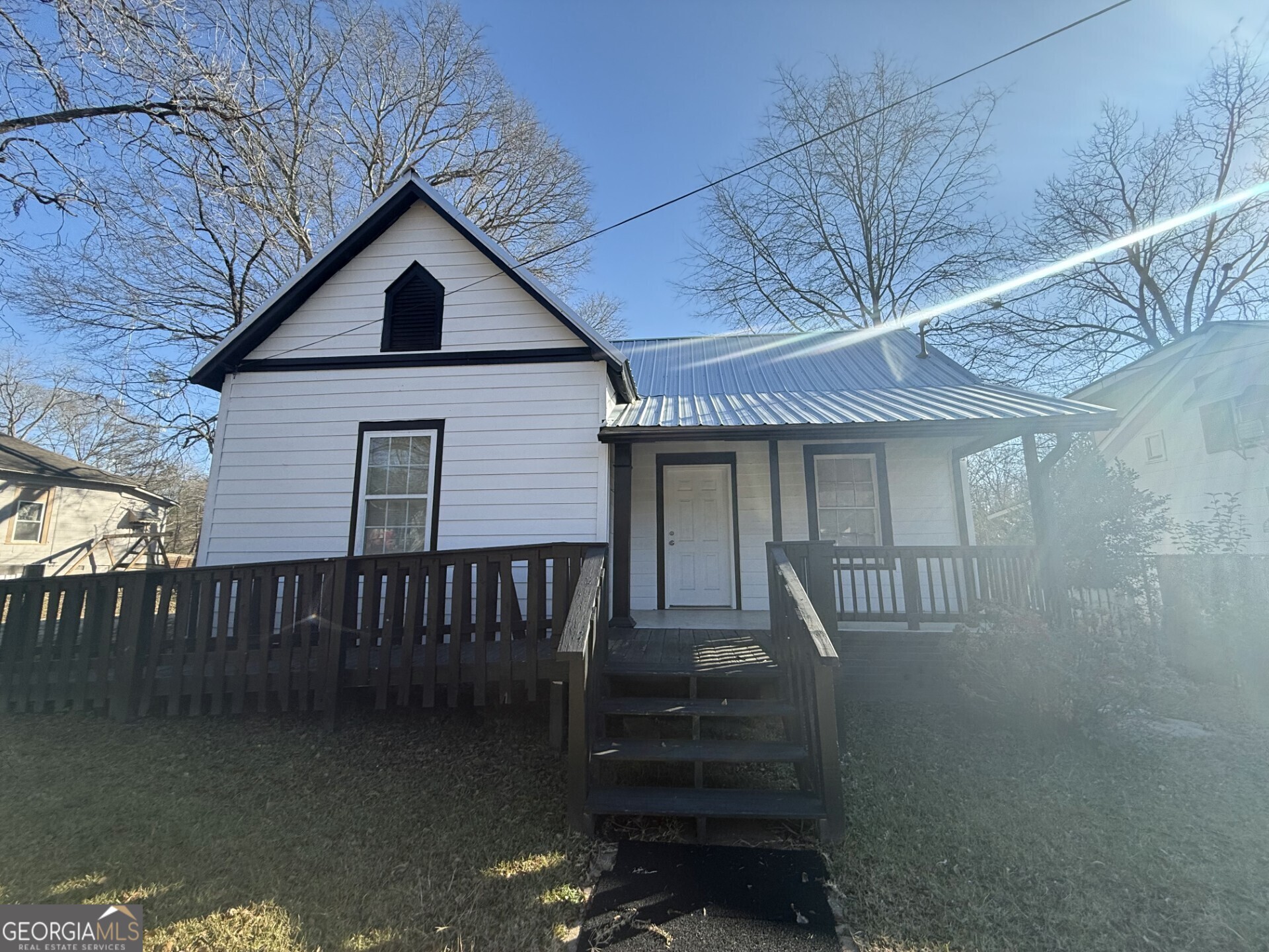 a view of a house with a small yard and wooden floor
