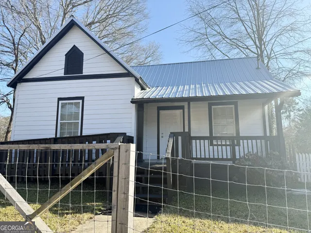 a view of a house with a door and wooden floor