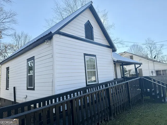 a view of a house with wooden fence