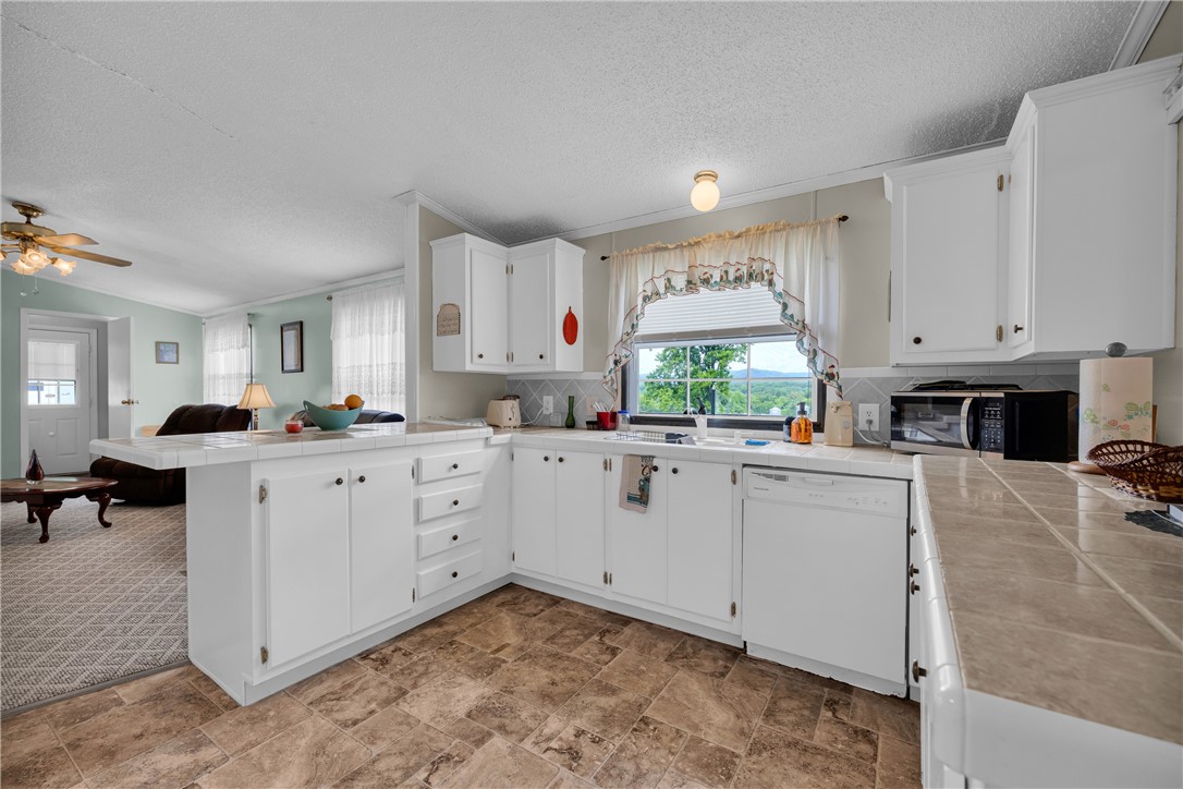 721 Cedar Crest Trail Walhalla, SC 29691 - Photo 10 of 47 A well-appointed kitchen boasts ample counter space, bright cabinetry, and a picturesque window view of the mountains.
