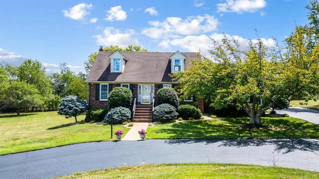 a view of a house with swimming pool and yard