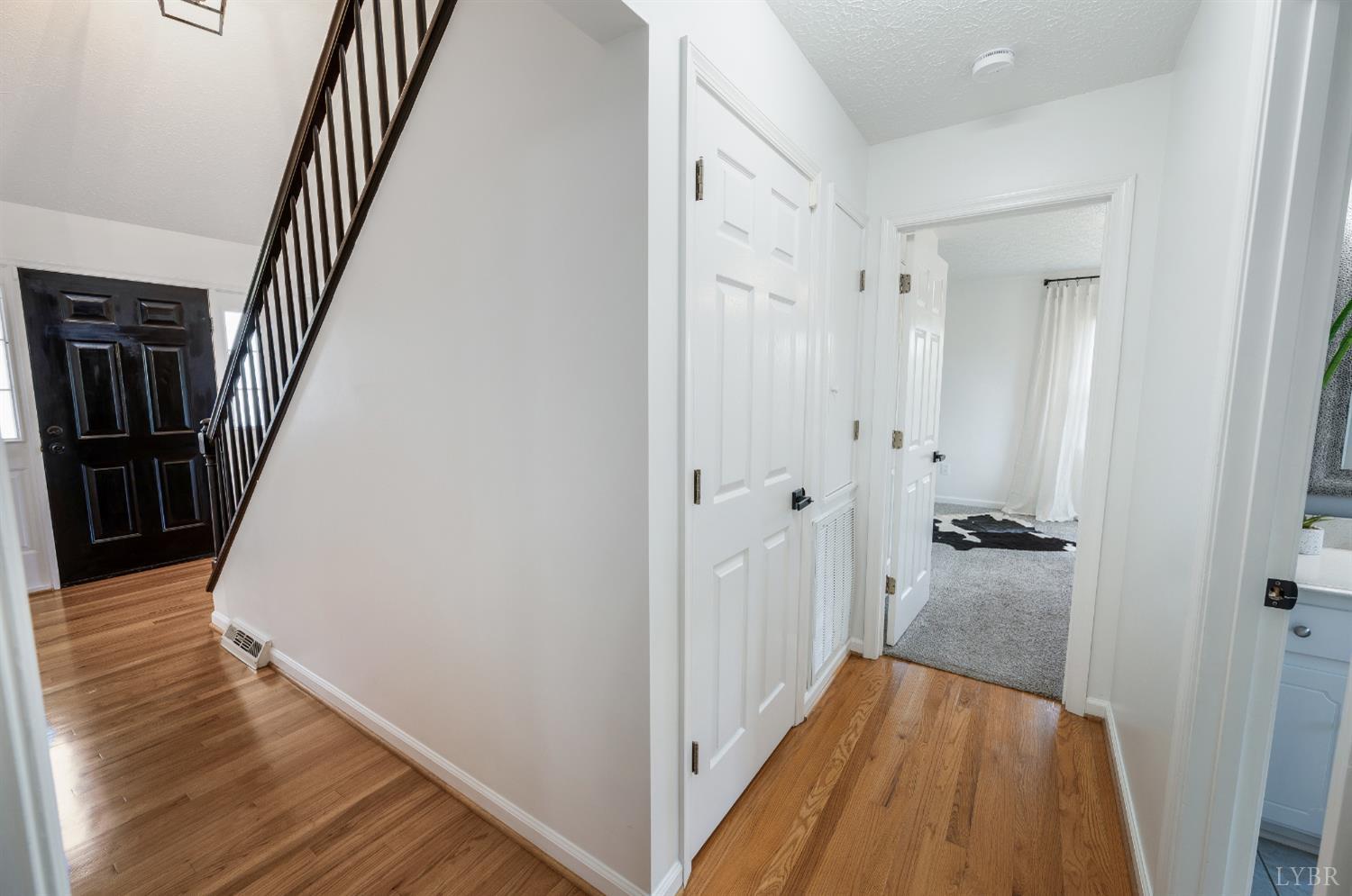 1199 Great Oak Road Forest, VA 24551 - Photo 14 of 85 a view of a hallway with wooden floor and staircase