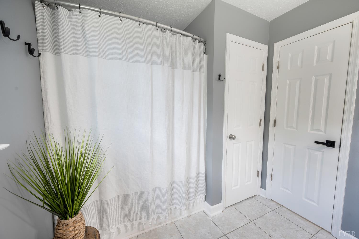 1199 Great Oak Road Forest, VA 24551 - Photo 16 of 85 a view of a bathroom with a shower curtain