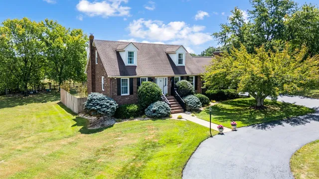 a view of a house with swimming pool and yard with green space