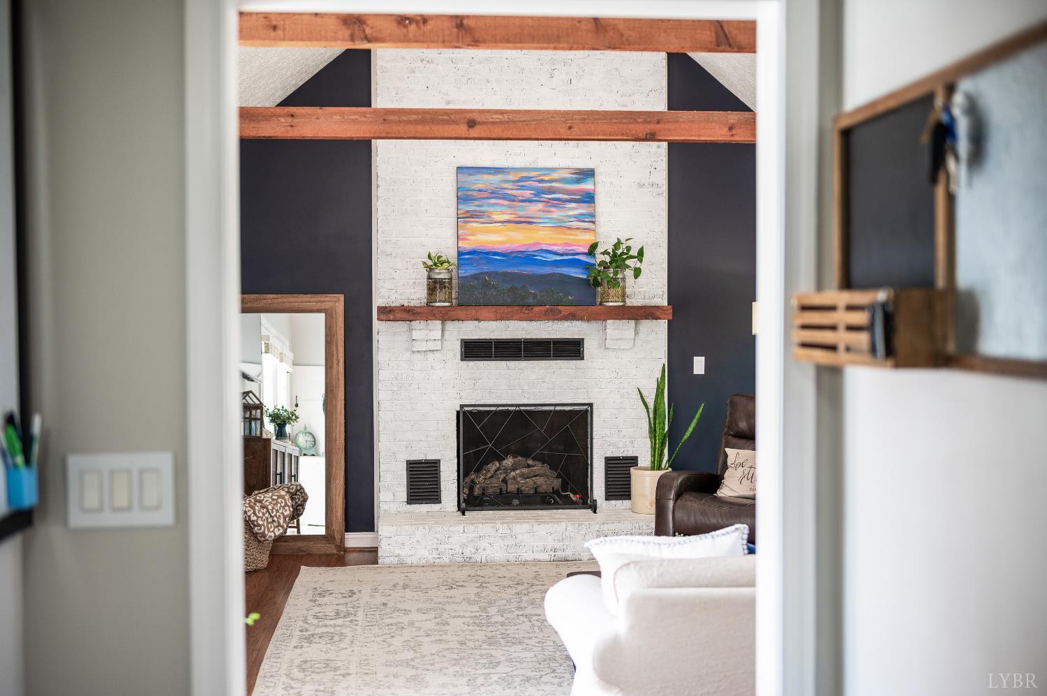 1199 Great Oak Road Forest, VA 24551 - Photo 32 of 85 a living room with furniture a fireplace and a flat screen tv