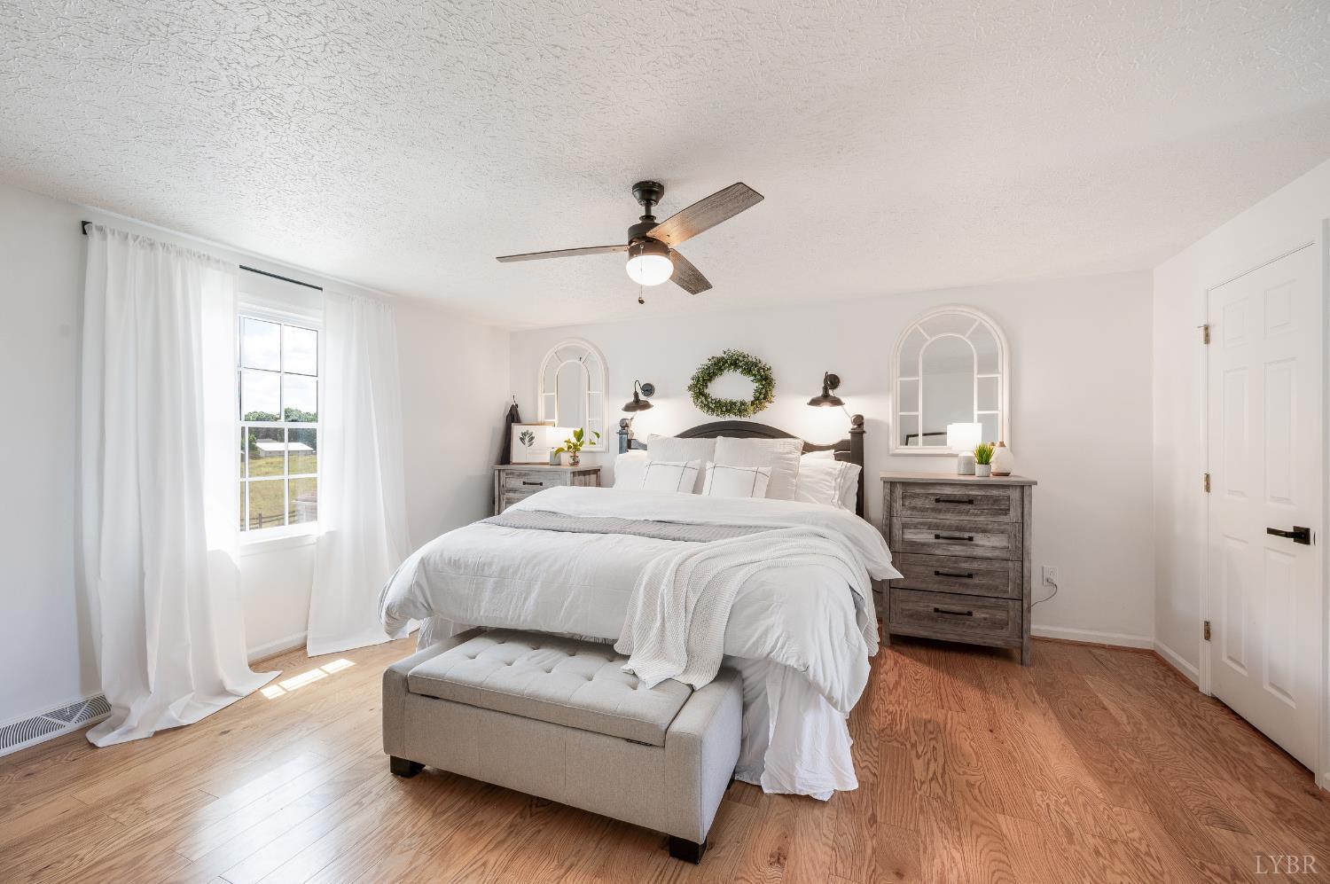 1199 Great Oak Road Forest, VA 24551 - Photo 36 of 85 a bedroom with a bed and wooden floor