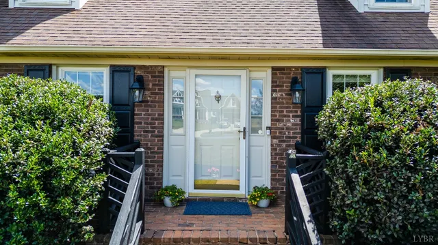 a view of a hallway with wooden floor and stairs