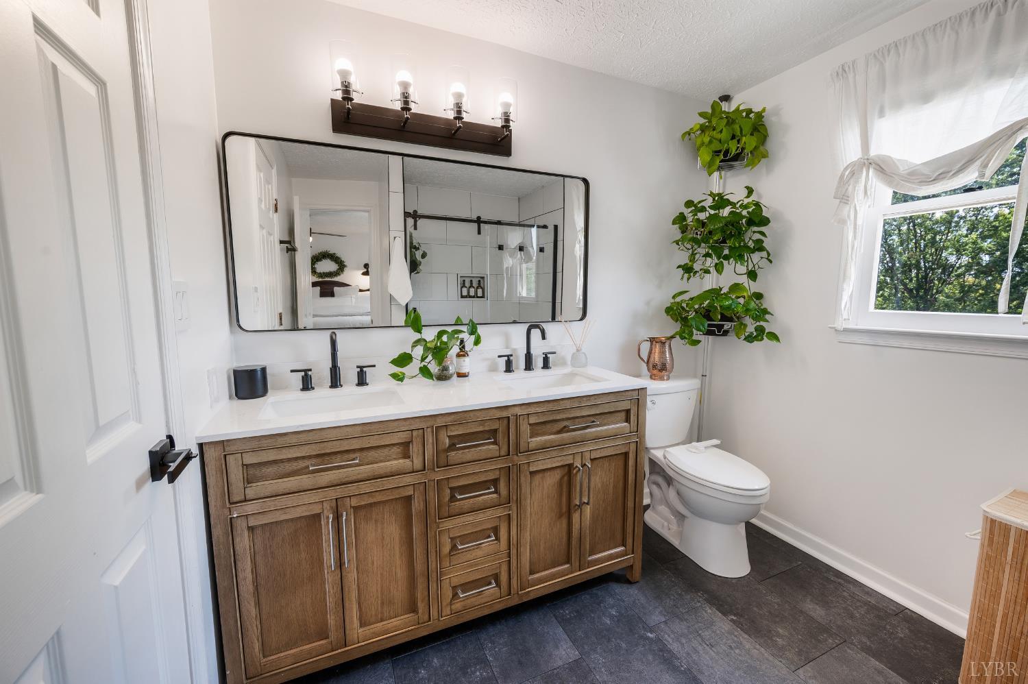 1199 Great Oak Road Forest, VA 24551 - Photo 41 of 85 a spacious bathroom with a toilet sink and mirror