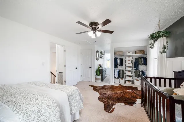 an aerial view of a house with swimming pool and large trees