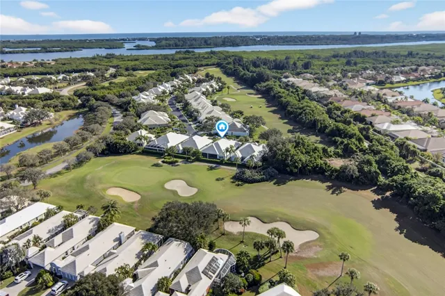 an aerial view of a houses with yard