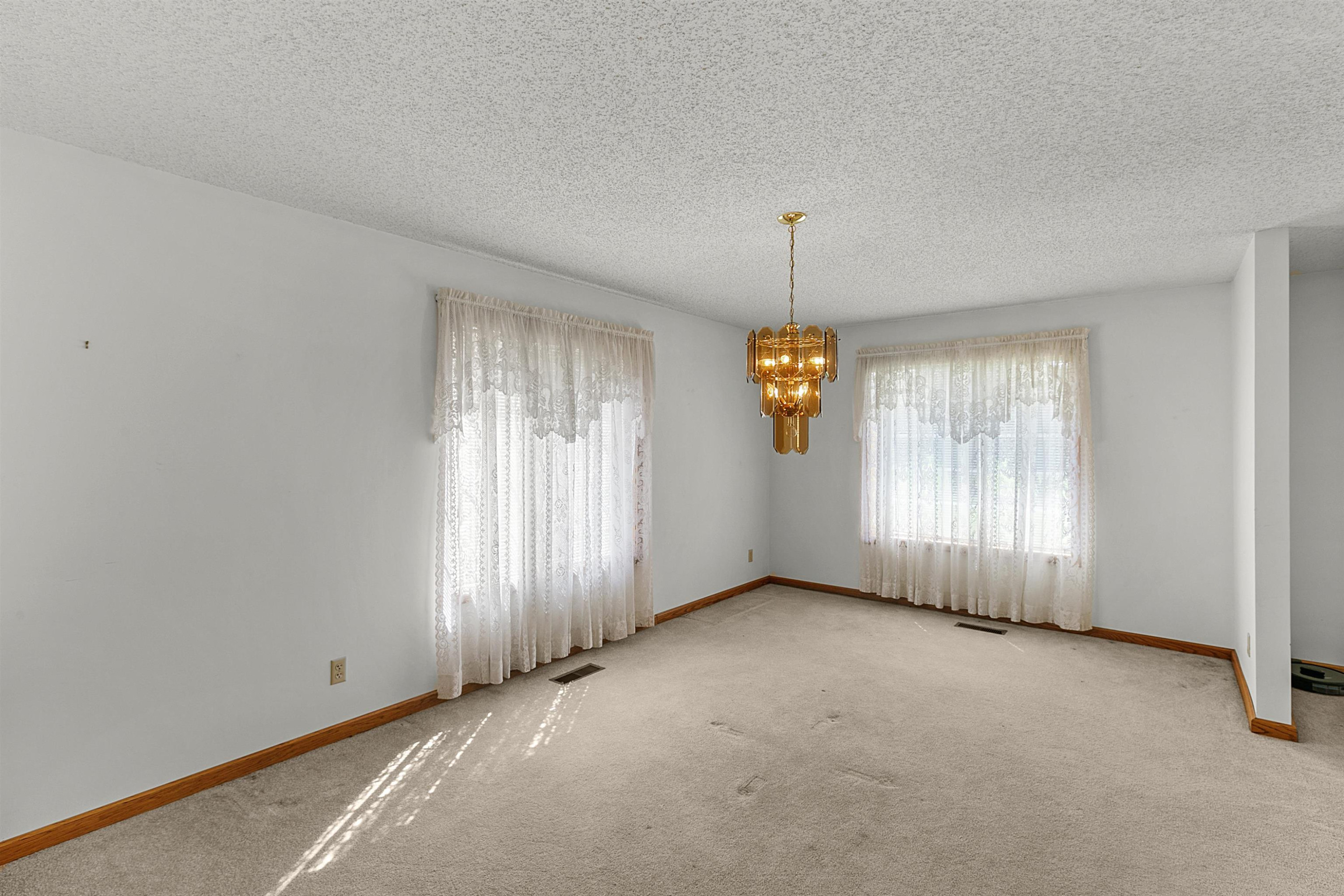 780 Griggs Chapel Road Cedar Grove, TN 38321 - Photo 13 of 25 an empty room with windows and chandelier fan