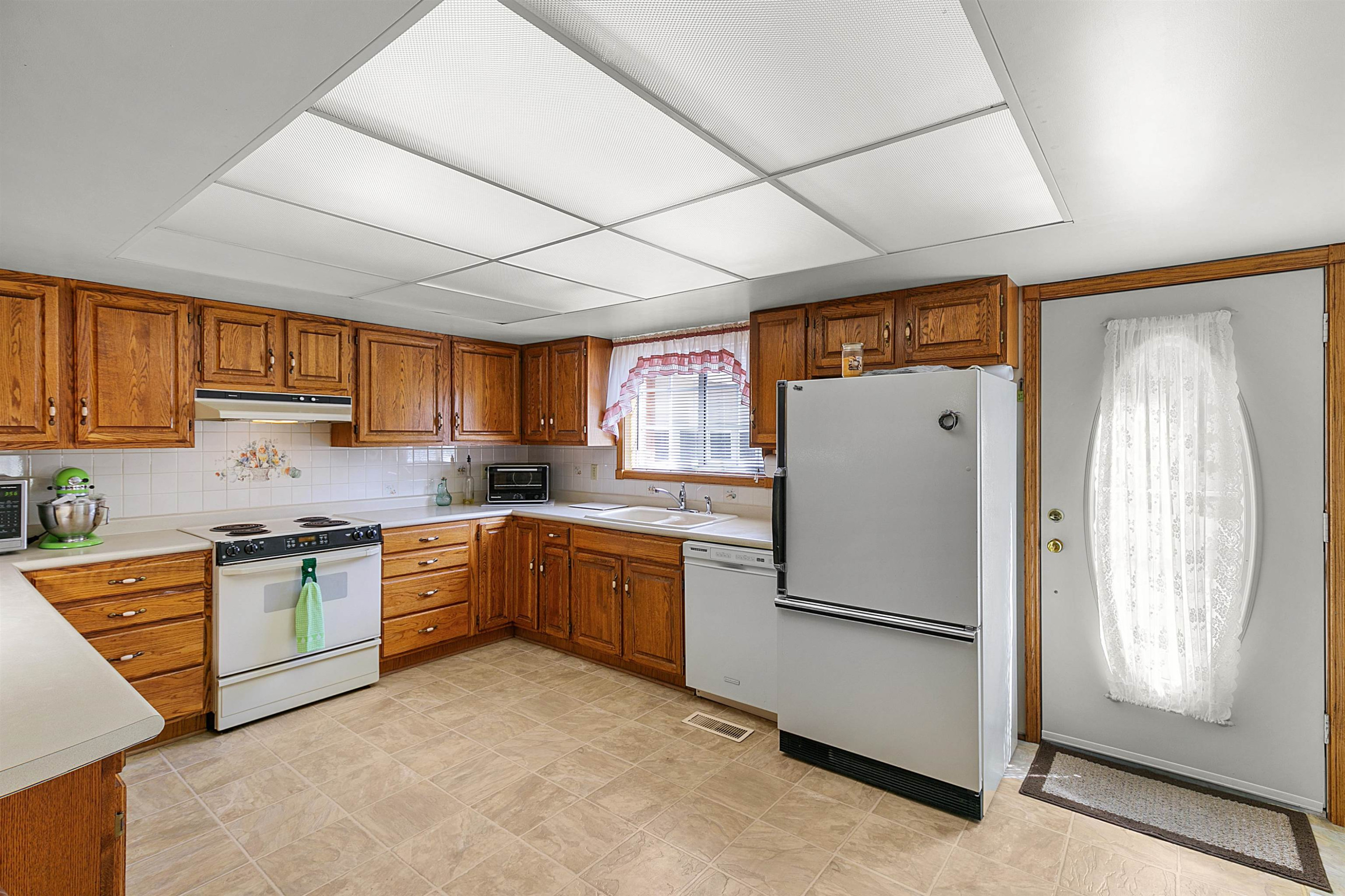 780 Griggs Chapel Road Cedar Grove, TN 38321 - Photo 4 of 25 a kitchen with stainless steel appliances granite countertop a refrigerator a sink dishwasher a stove with wooden cabinets and floor