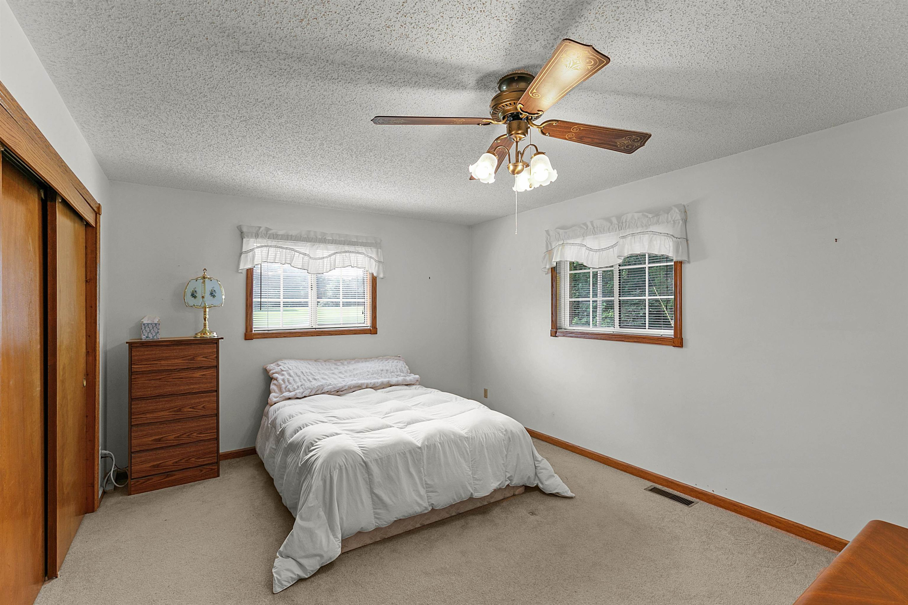 780 Griggs Chapel Road Cedar Grove, TN 38321 - Photo 10 of 25 a bedroom with a bed and a chandelier