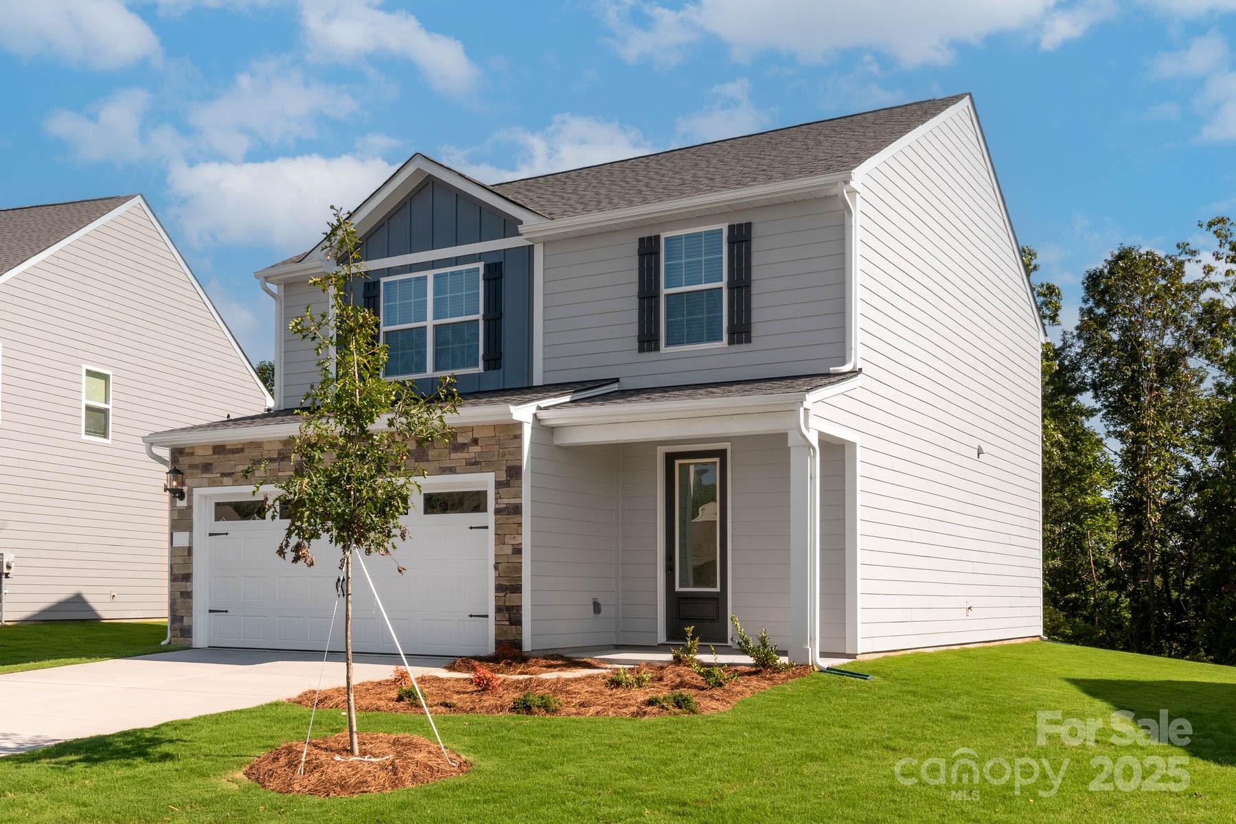 280 Limestone Terrace Mills River, NC 28759 - Photo 2 of 22 a front view of a house with a yard and garage
