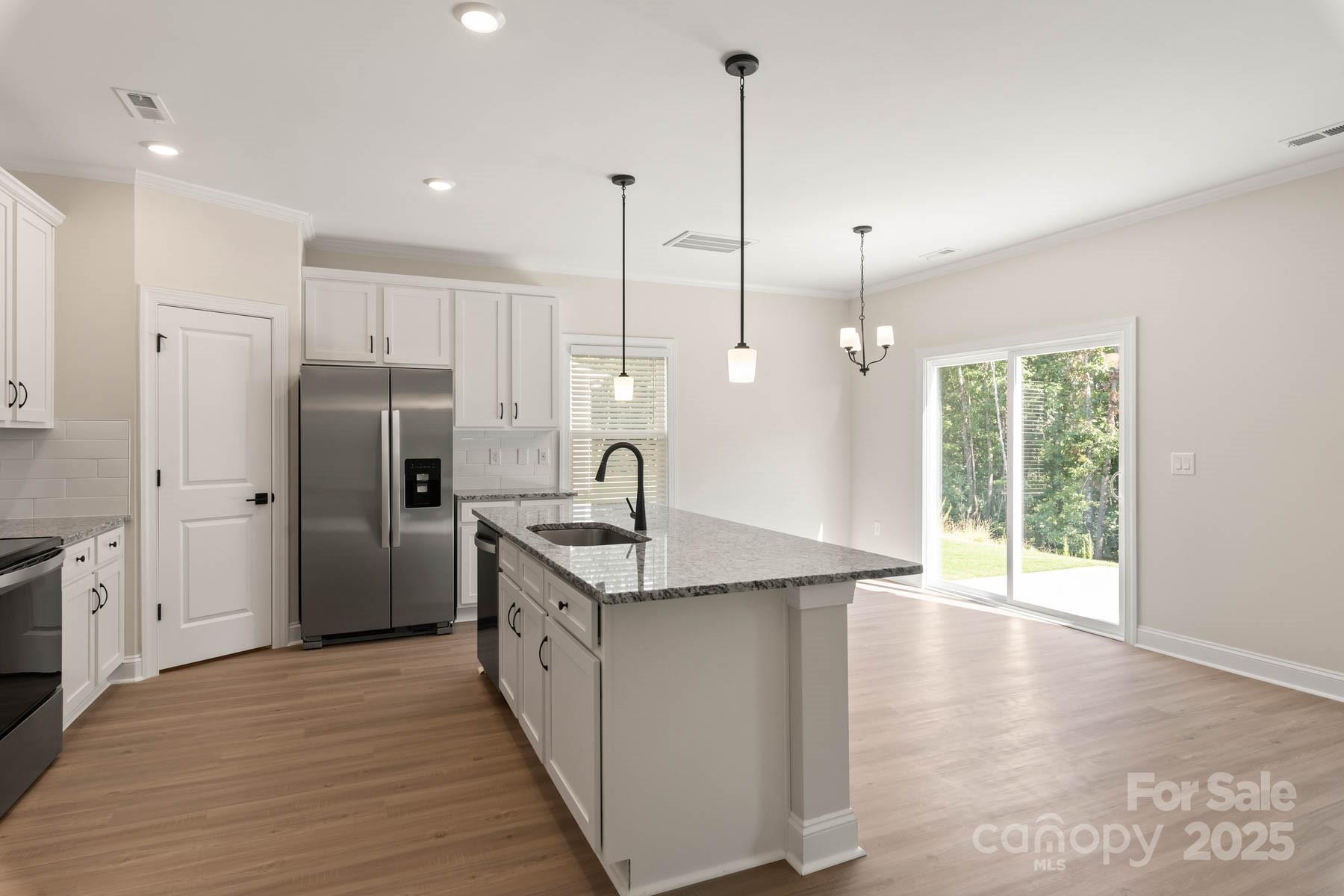 280 Limestone Terrace Mills River, NC 28759 - Photo 6 of 22 a kitchen with stainless steel appliances granite countertop a refrigerator a sink and a wooden floor