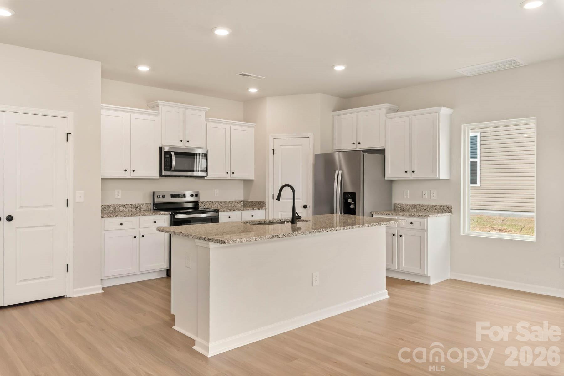 280 Limestone Terrace Salisbury, NC 28146 - Photo 10 of 21 a kitchen with white cabinets and appliances