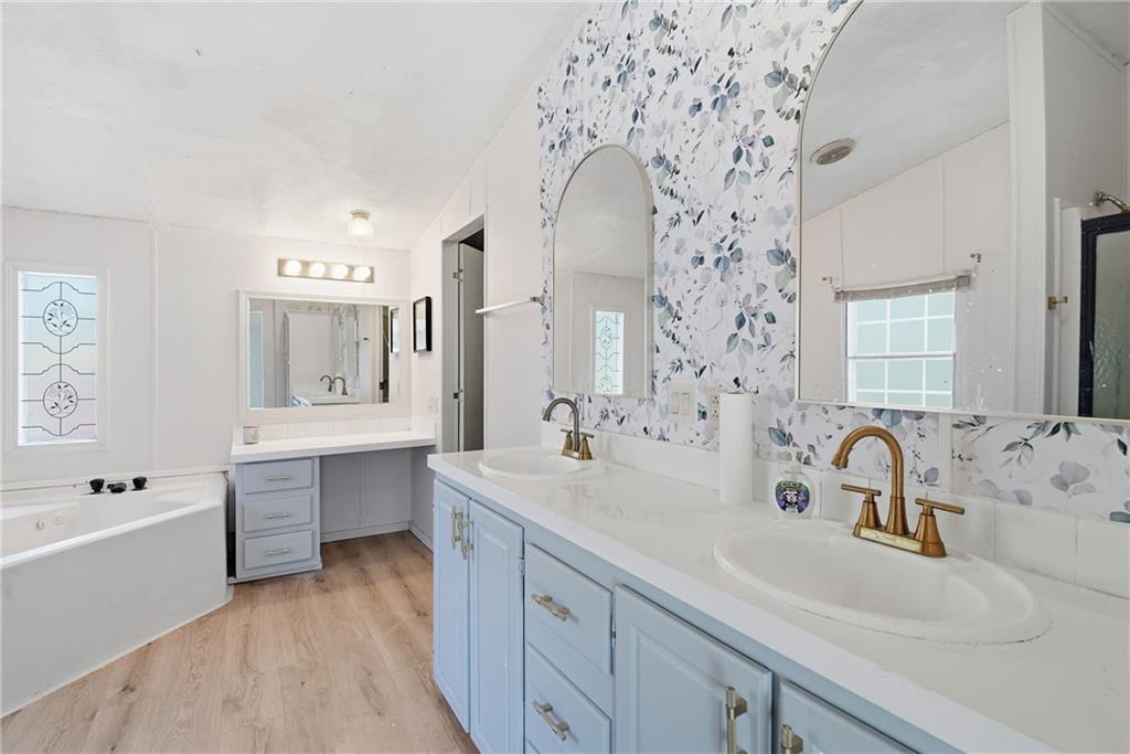 1265 Barfield Road Southwest Townsend, GA 31331 - Photo 20 of 30 a spacious bathroom with double vanity sinks a mirror and a bathtub