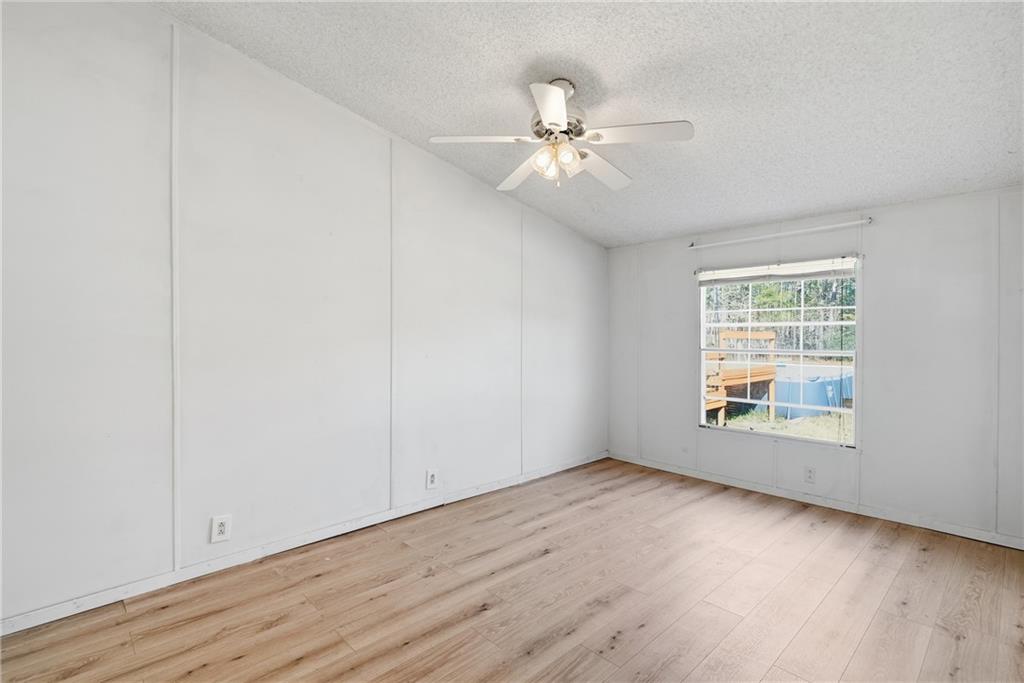 1265 Barfield Road Southwest Townsend, GA 31331 - Photo 23 of 30 a view of an empty room with wooden floor and a window