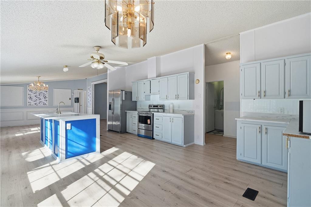 1265 Barfield Road Southwest Townsend, GA 31331 - Photo 8 of 30 a kitchen with stainless steel appliances kitchen island granite countertop a refrigerator and a stove top oven