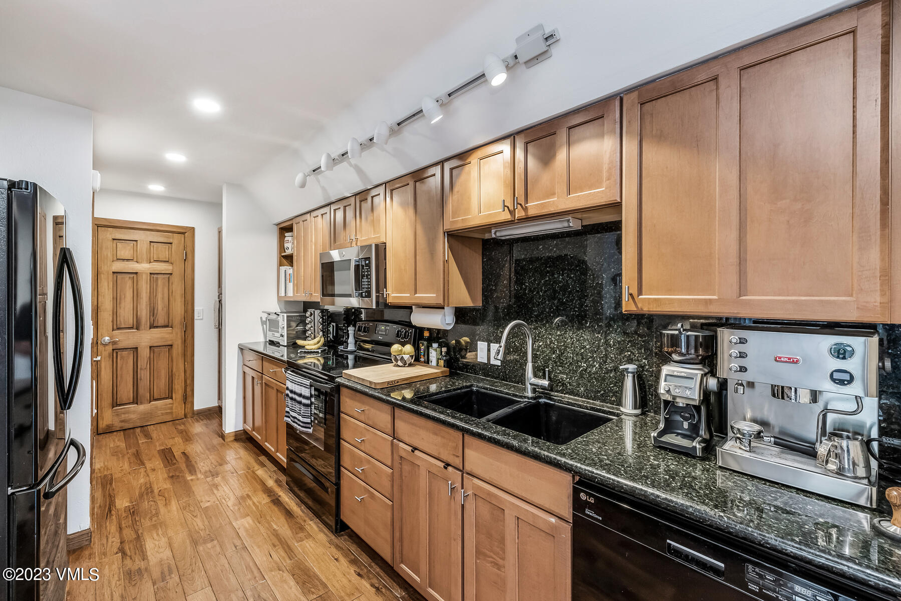 16 Eagle-Vail Road, Unit A1 Eagle-Vail, CO 81620 - Photo 11 of 30 a kitchen with granite countertop stainless steel appliances a sink stove top oven and cabinets