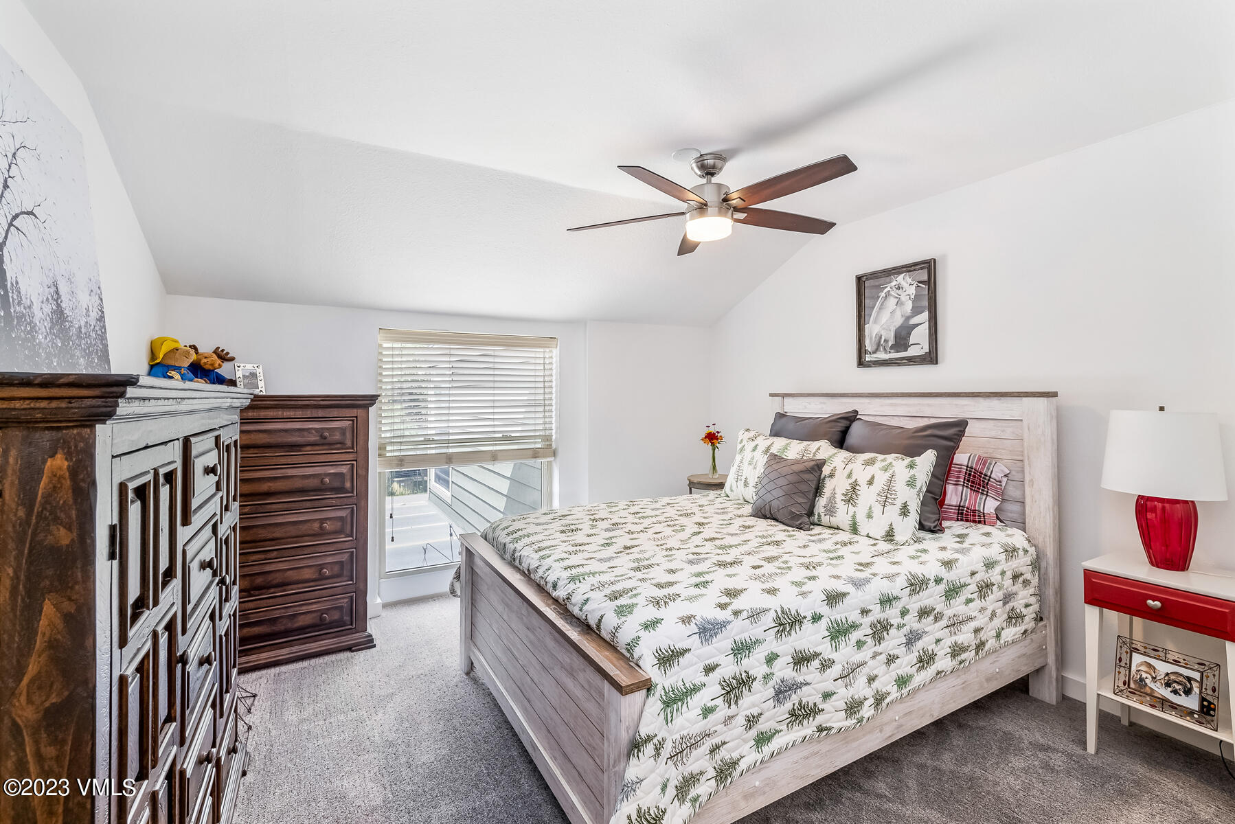 16 Eagle-Vail Road, Unit A1 Eagle-Vail, CO 81620 - Photo 19 of 30 a bedroom with a bed and a chandelier