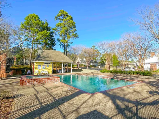a view of a swimming pool with a patio