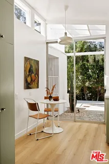 a kitchen with stainless steel appliances a sink a stove a refrigerator and cabinets