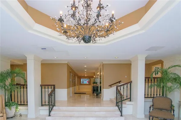 a view of a livingroom with furniture and floor to ceiling window