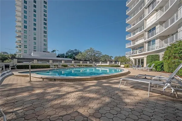 a view of a swimming pool with a lounge chairs
