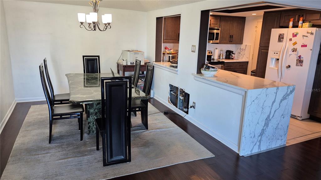 2611 Bayshore Boulevard, Unit 806 Tampa, FL 33629 - Photo 8 of 35 a view of a dining room with furniture and wooden floor