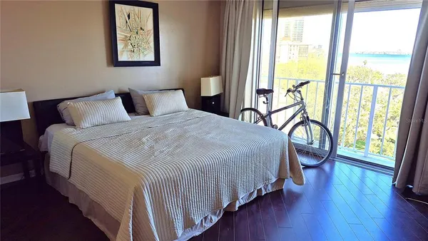 a bedroom with a bed and a large window