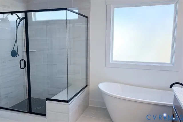 a bathroom with a bathtub and shower