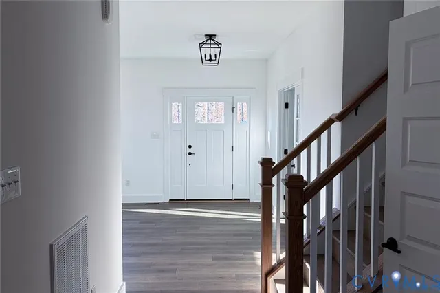 a view of an entryway with wooden floor