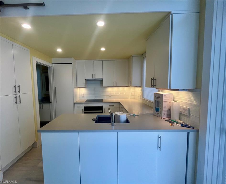 4931 Coach Lane Naples, FL 34114 - Photo 13 of 13 a kitchen with a refrigerator and a stove top oven