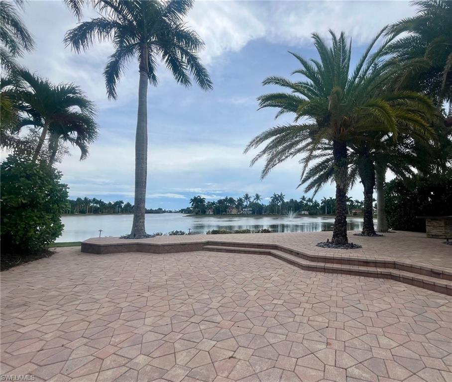 4931 Coach Lane Naples, FL 34114 - Photo 5 of 13 a swimming pool with a lawn chair and palm trees