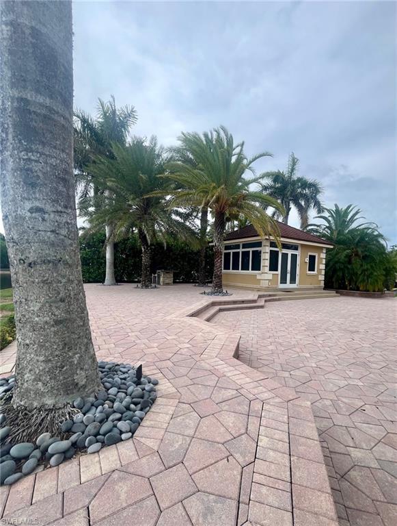 4931 Coach Lane Naples, FL 34114 - Photo 7 of 13 a front view of a house with a yard