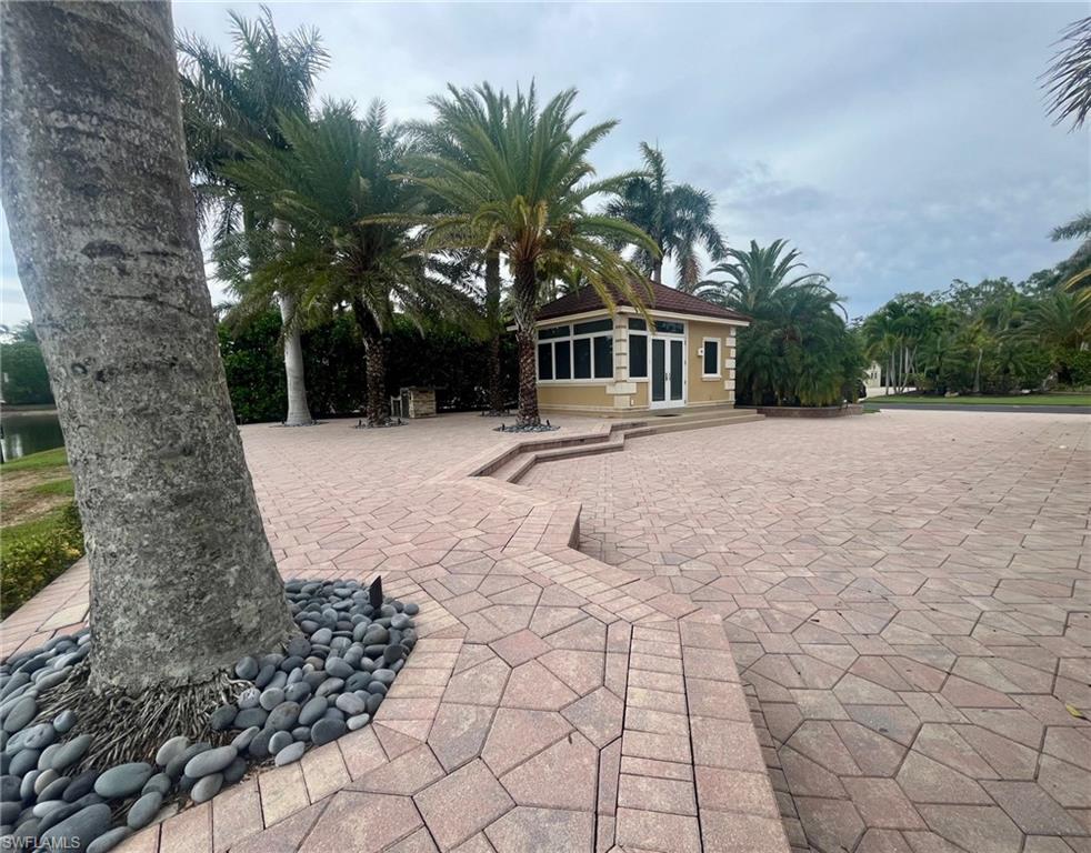 4931 Coach Lane Naples, FL 34114 - Photo 8 of 13 a front view of a house with a yard and trees