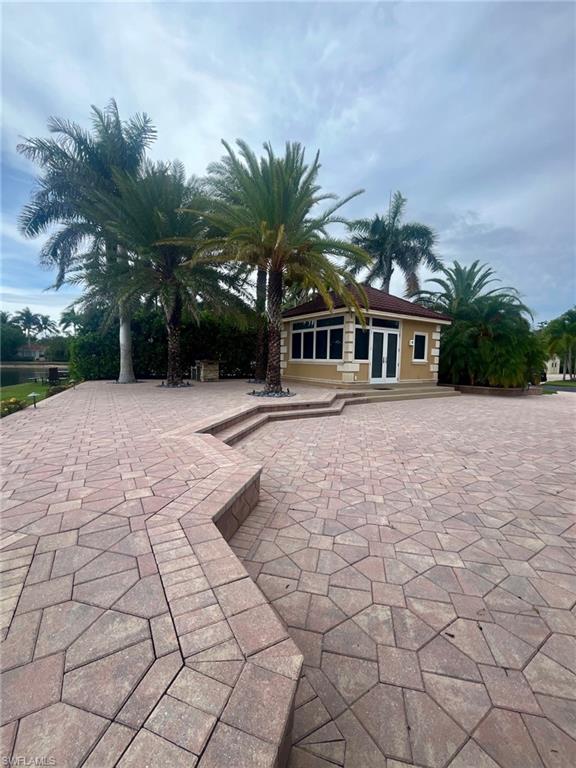 4931 Coach Lane Naples, FL 34114 - Photo 9 of 13 a view of house with yard and trees around