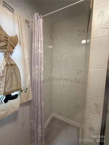 a bathroom with a shower and a tub