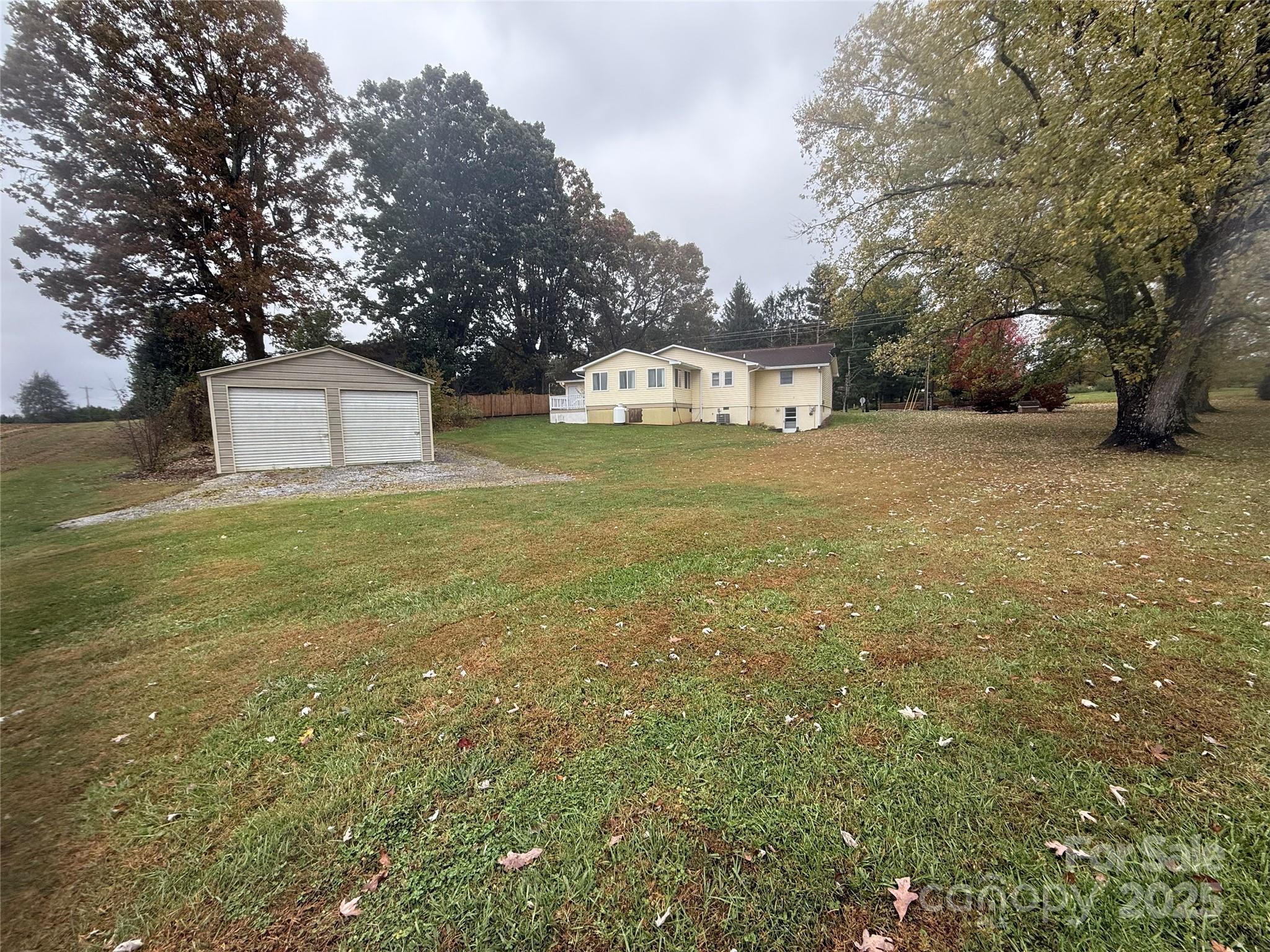 5601 Howard Gap Road Flat Rock, NC 28731 - Photo 2 of 21 a front view of a house with a yard and trees
