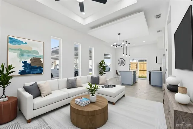 a living room with furniture kitchen view and a chandelier
