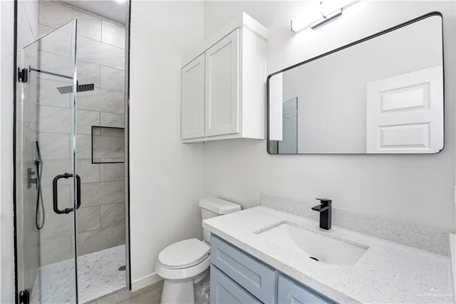 a bathroom with a sink toilet and shower