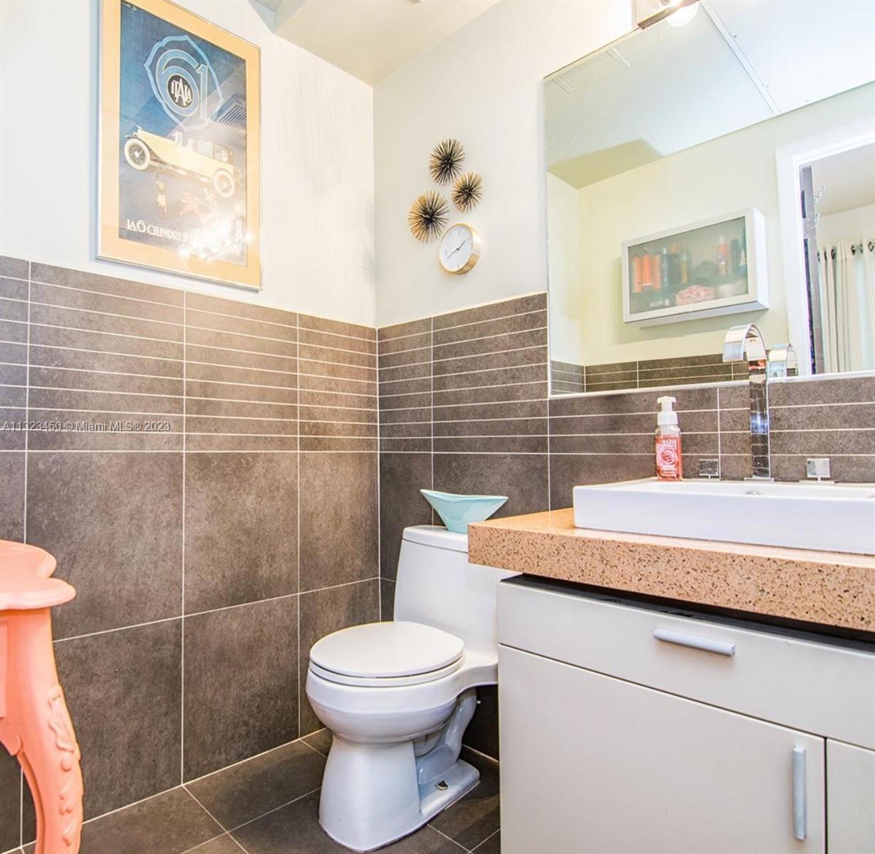 435 21st Street, Unit 223 Miami Beach, FL 33139 - Photo 5 of 6 a bathroom with a toilet and a sink