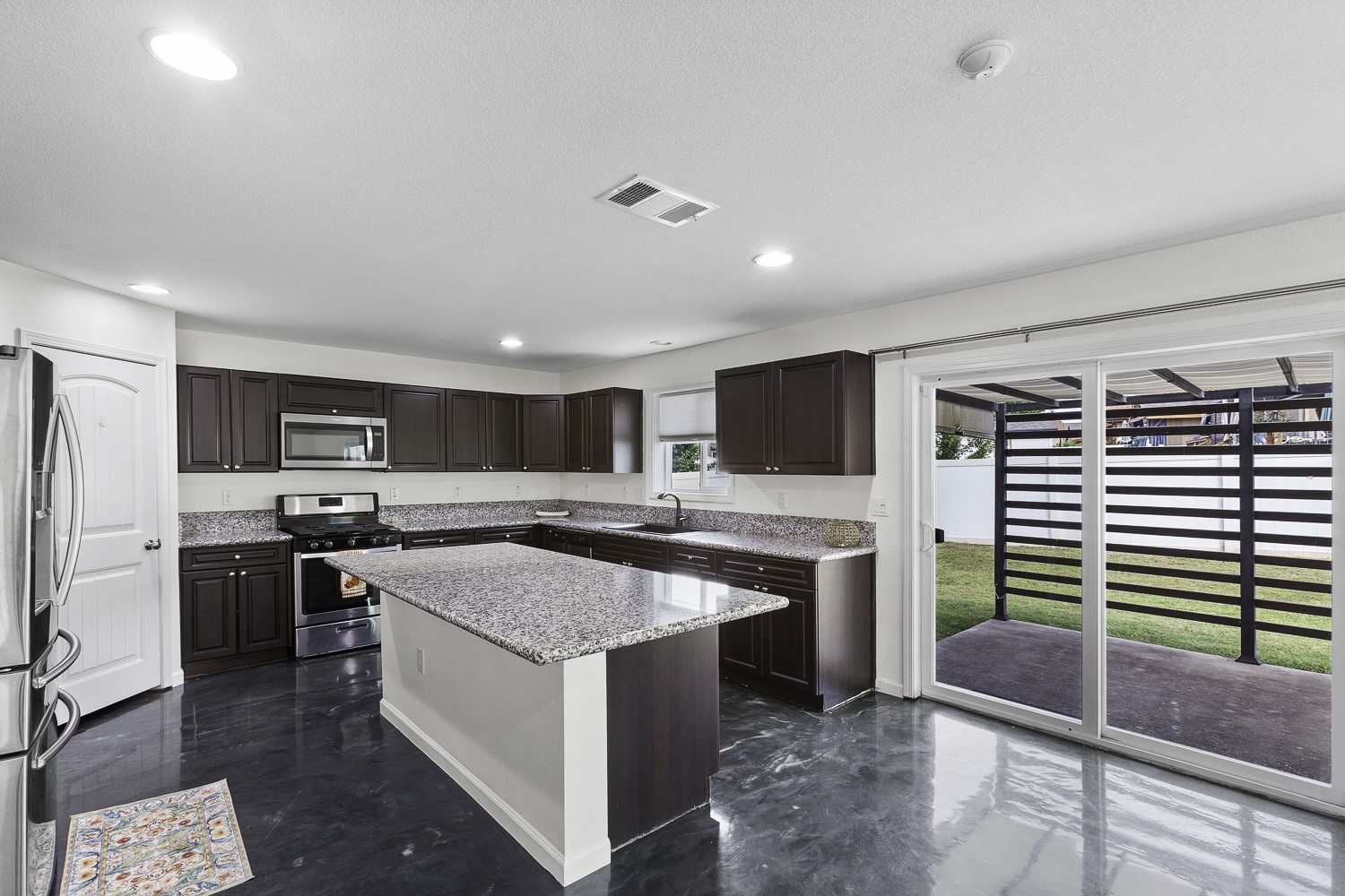 Undisclosed Address Austin, TX 78747 - Photo 5 of 28 a kitchen with stainless steel appliances granite countertop a sink stove and refrigerator