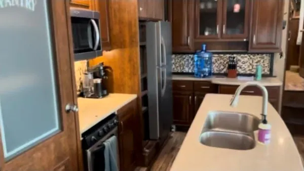 a kitchen with a refrigerator and a sink
