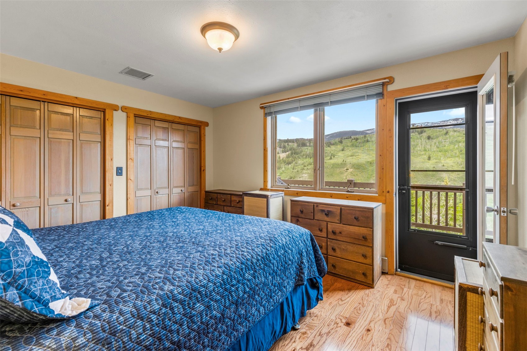1516 Blue Ridge Road Silverthorne, CO 80498 - Photo 18 of 50 Bedroom with multiple closets, light wood finished floors, and access to outside