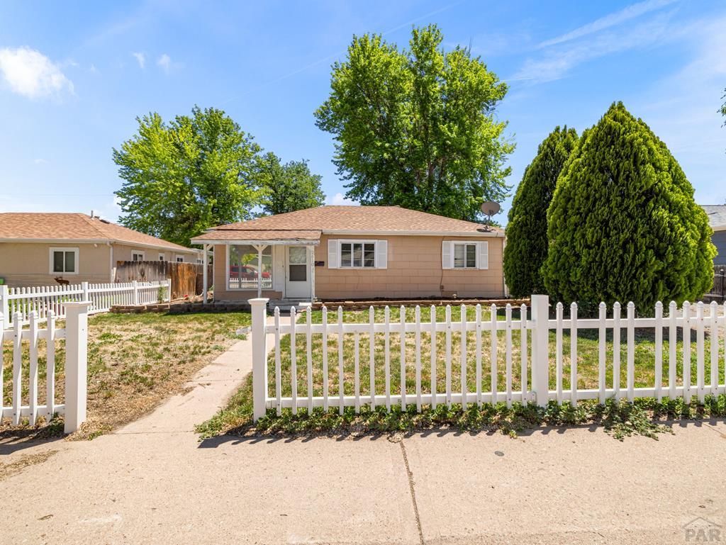 2610 Azalea Street Pueblo, CO 81005 - Photo 1 of 19 a front view of a house with a garden