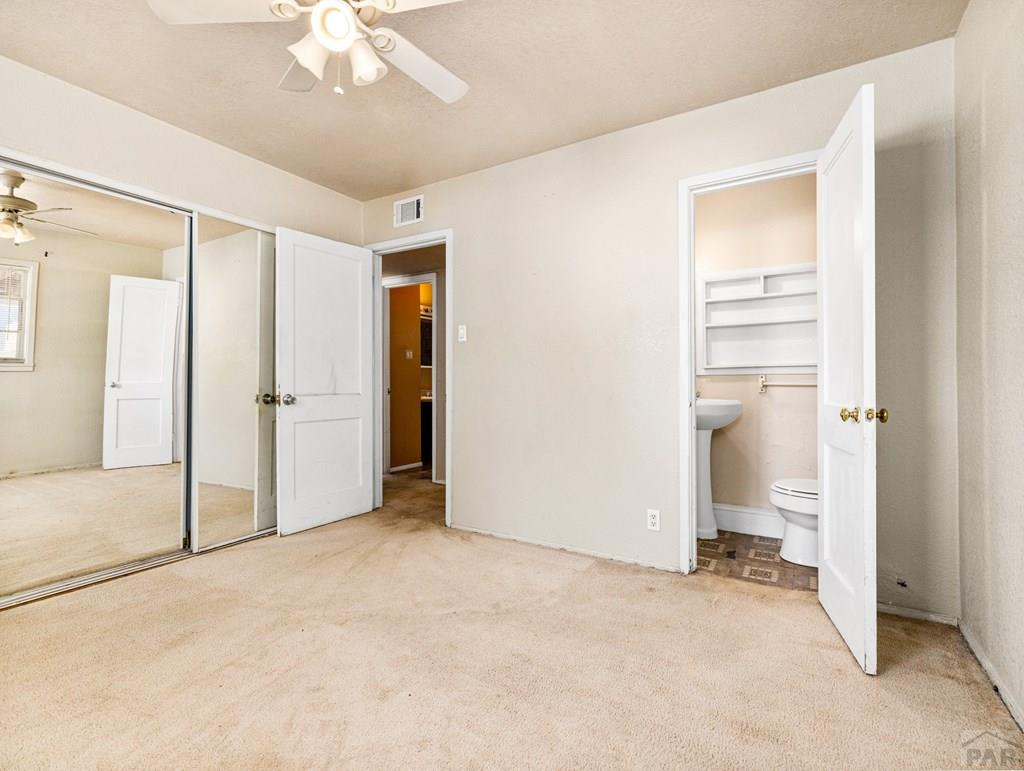 2610 Azalea Street Pueblo, CO 81005 - Photo 11 of 19 an empty room with an entryway and chandelier fan